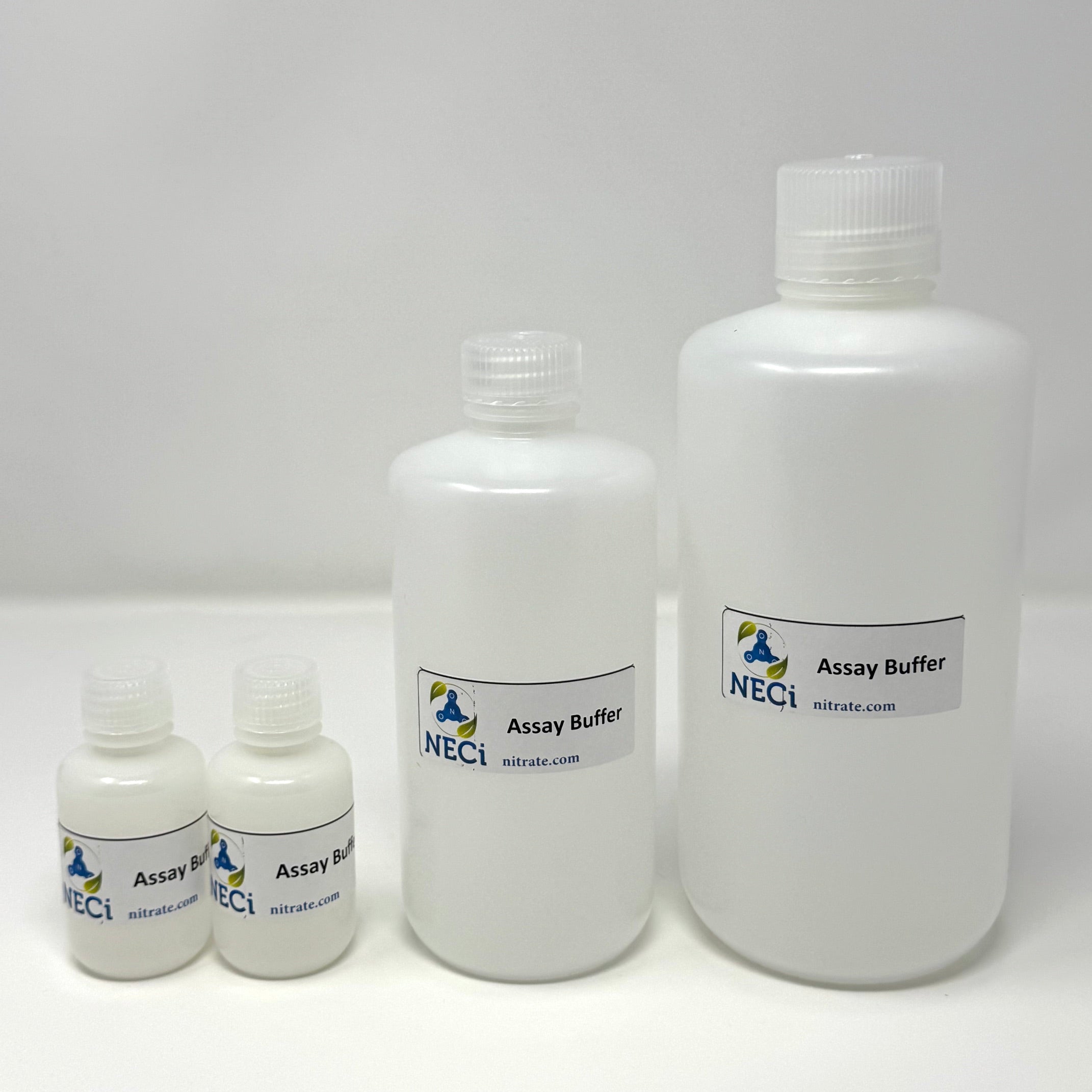 Four white plastic bottles of NECI Assay Buffer in different sizes, arranged from smallest to largest on a white background.